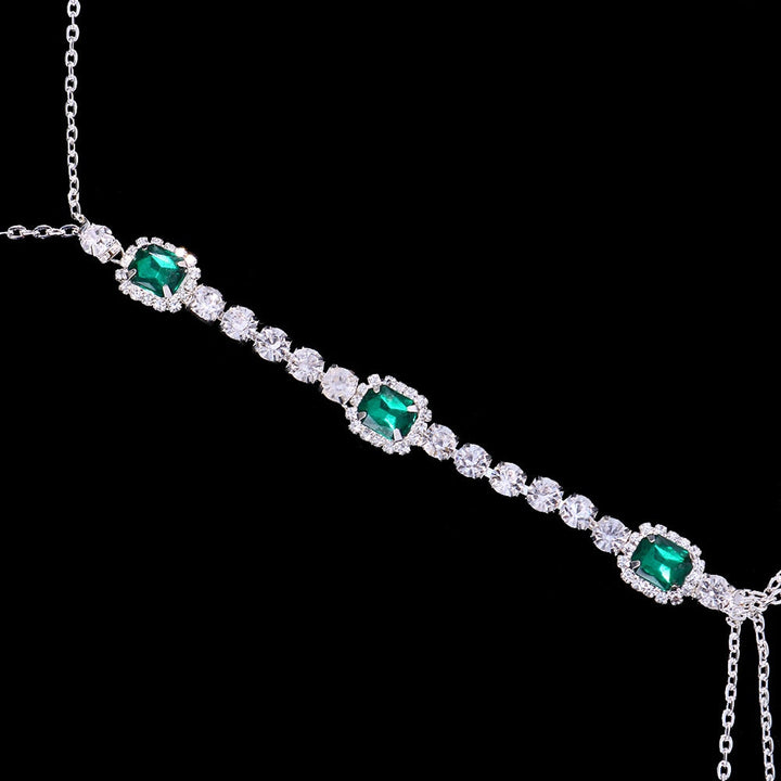 Close-up: Vibrant green crystal chest chain with shimmering rhinestones, highlighting the intricate craftsmanship.