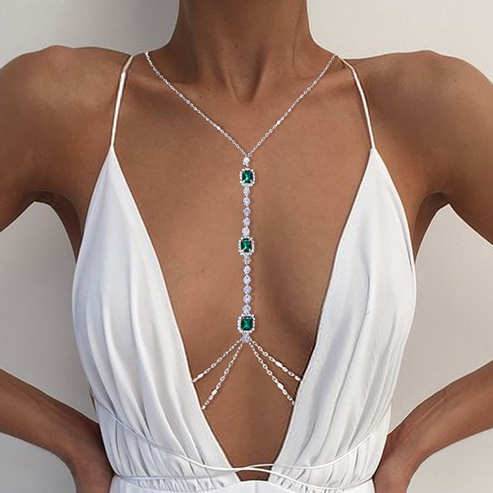 Sparkling green crystal chest body chain for women, featuring intricate rhinestones & a luxurious design.