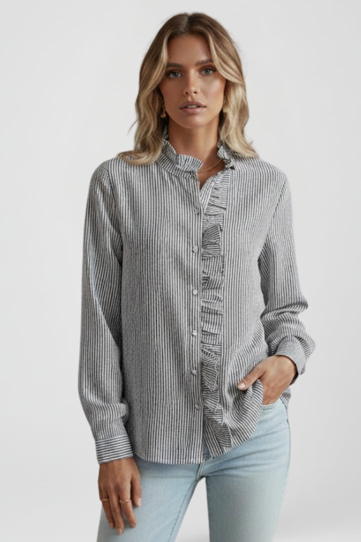 Full shot of a women's elegant ruffled long sleeve blouse. A versatile button-front top for office and casual fashion.