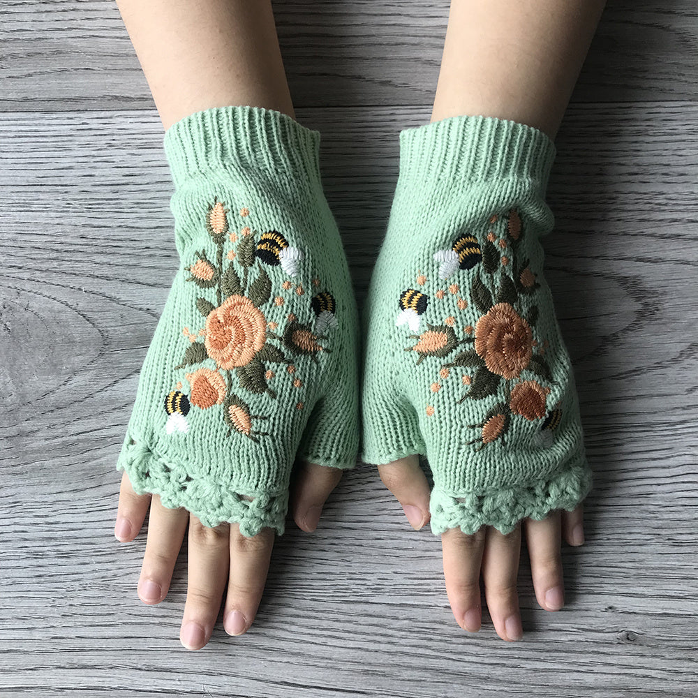 Knit women's fingerless gloves with beautiful floral hand embroidery, a chic accessory for cold weather.
