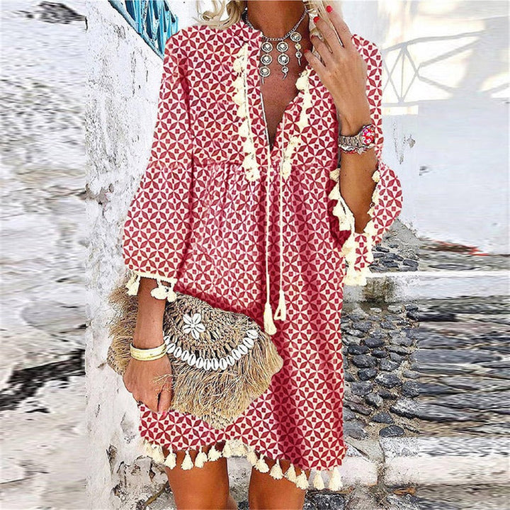 Fashionable women's mini dress with a flattering V-neck, bohemian tassels & bell sleeves for chic casual outfits.