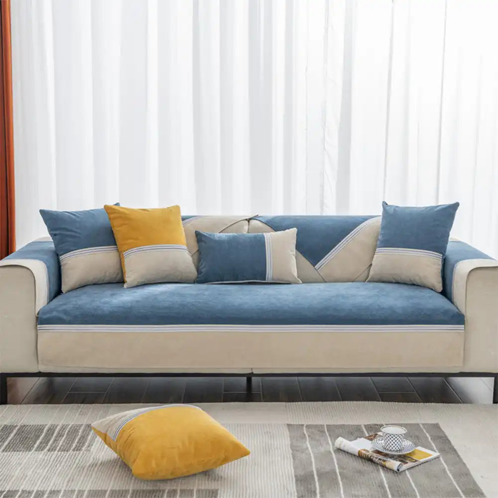 Stylish home decor using a water-resistant colorblock couch cover on a living room sofa.