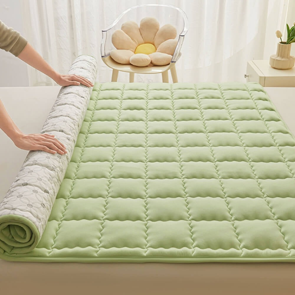 Soft bedding with a breathable, quilted mattress topper, highlighting its plush comfort and design