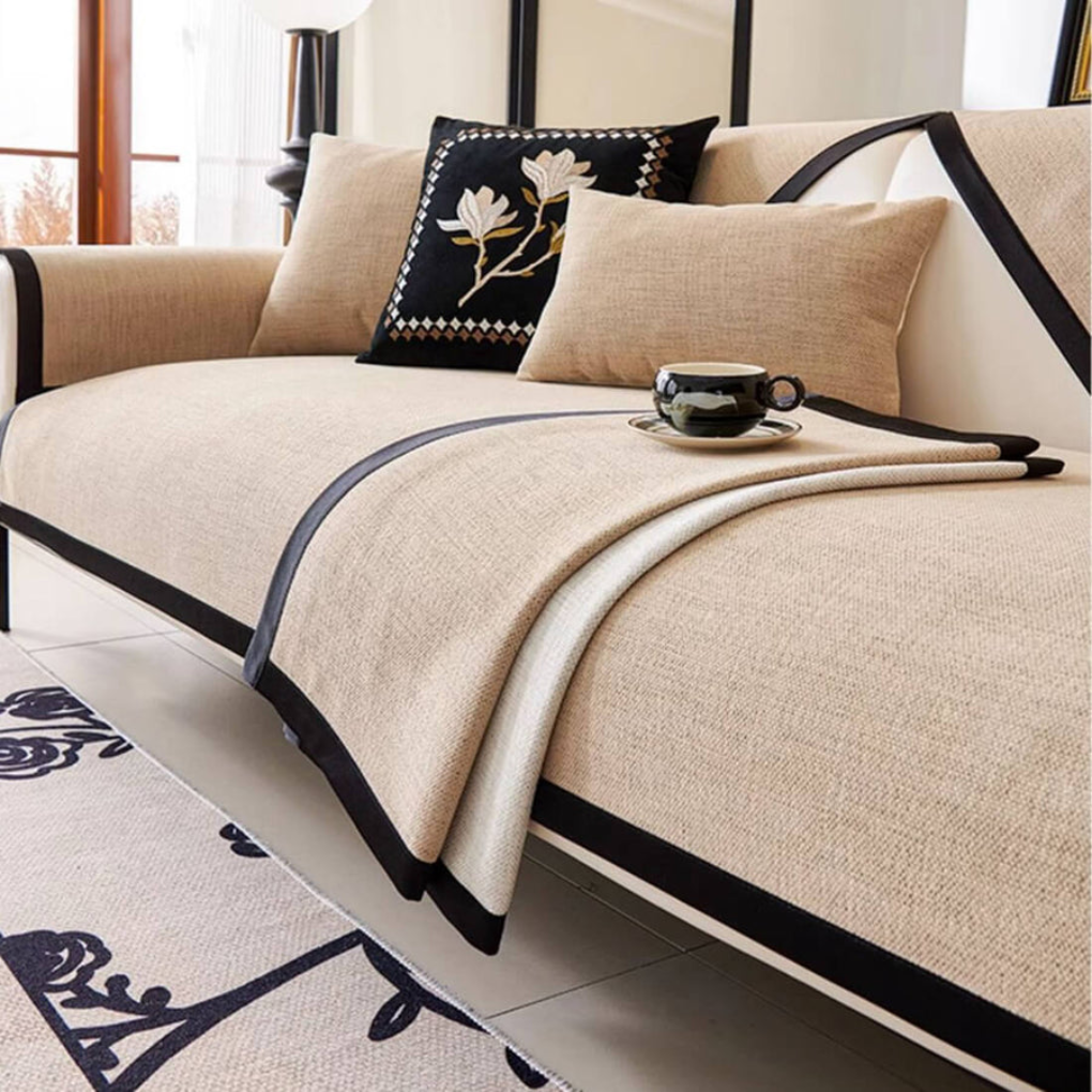 Full view of a living room sofa protected by an anti-slip sectional cover with charming tassels.