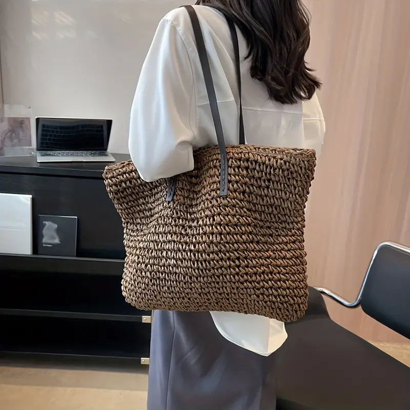 Front view: Women's oversized woven straw beach tote bag, showcasing its casual summer appeal.