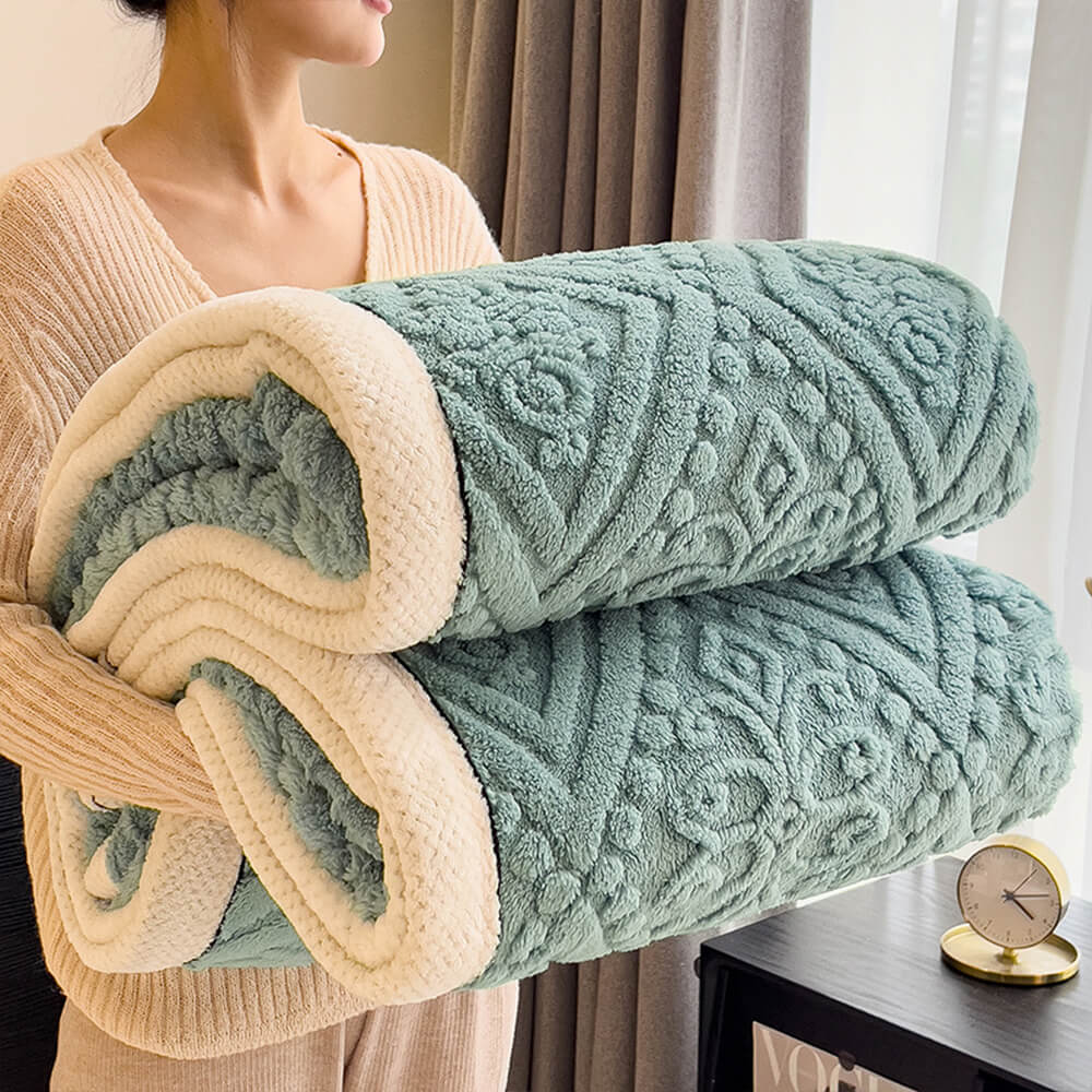 Close-up of Baroque embossed pattern on a milk velvet fleece blanket, warm & soft luxury