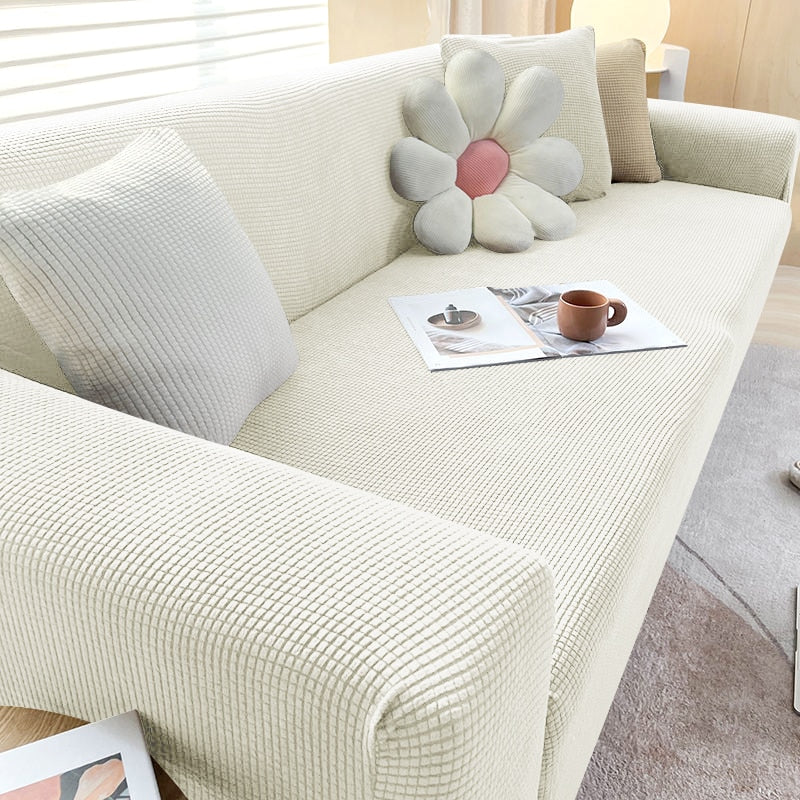 Beige Sofahusse aus elastischem Stretchmaterial, perfekter Sitz, Schutz vor Flecken, Schmutz und Tierhaaren.