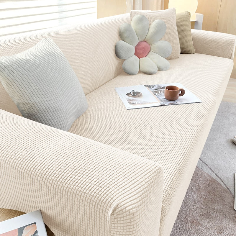 Beige Sofahusse aus elastischem Stretchmaterial, perfekter Sitz, Schutz vor Flecken, Schmutz und Tierhaaren.