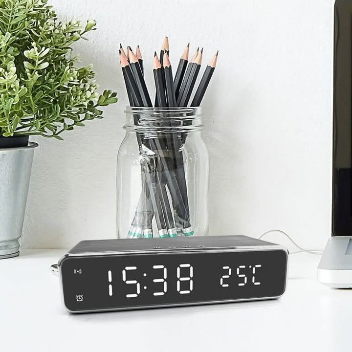 Black digital LED alarm clock with wireless phone charger, ideal modern tech accessory for bedside tables.