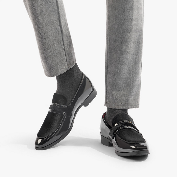 Pair of elegant men's navy slip-on dress shoes. Stylish formal footwear for office or evening.