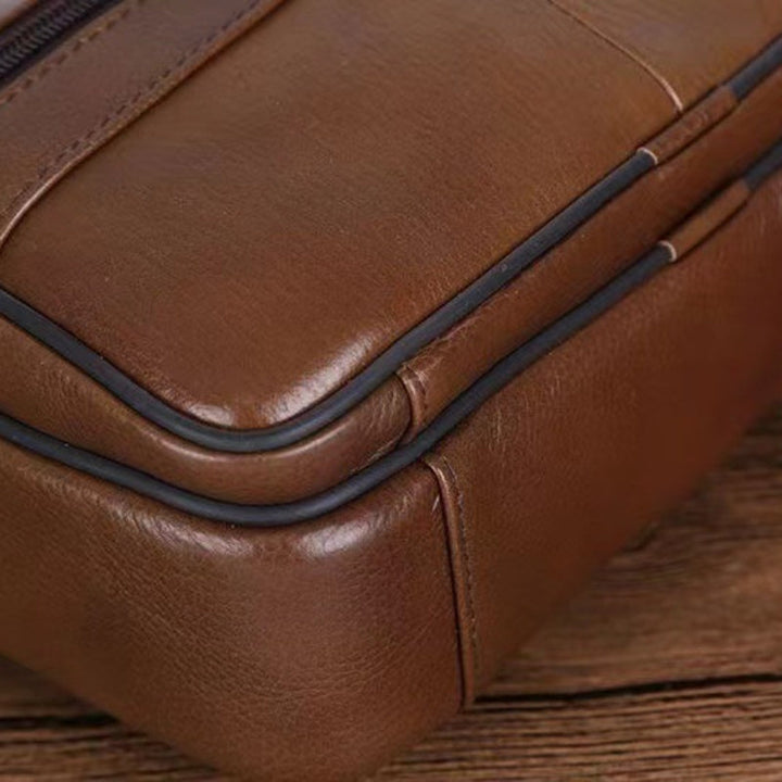 Sleek black men's crossbody bag, designed for secure everyday carry & travel convenience.