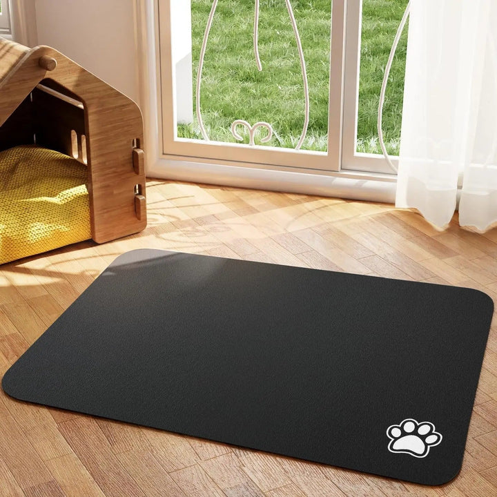 Black unisex absorbent non-slip pet feeding mat in a kitchen setting with food bowls on top