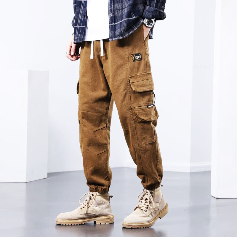 Khaki men's fashionable utility cargo pants, comfortable for everyday wear. Versatile multi-pocket design for casual or work.