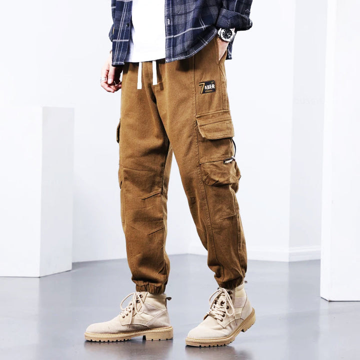Khaki men's fashionable utility cargo pants, comfortable for everyday wear. Versatile multi-pocket design for casual or work.