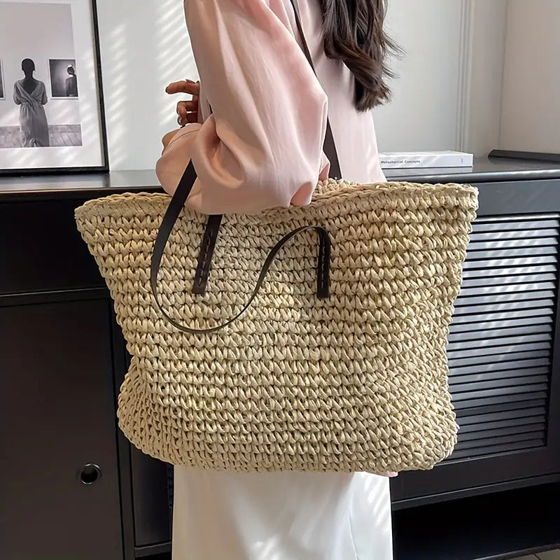 Natural texture of a women's oversized woven straw beach tote bag, highlighting summer fashion.