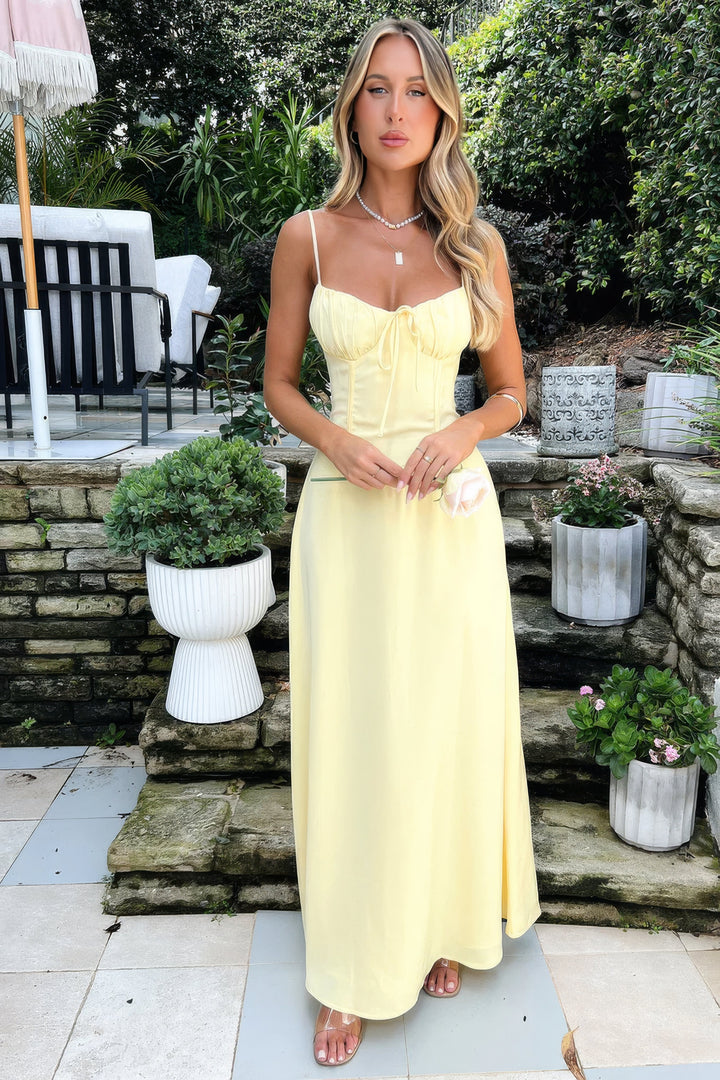 Stylish sleeveless A-line maxi dress for women, featuring a trendy tie-front. Elegant for any occasion.