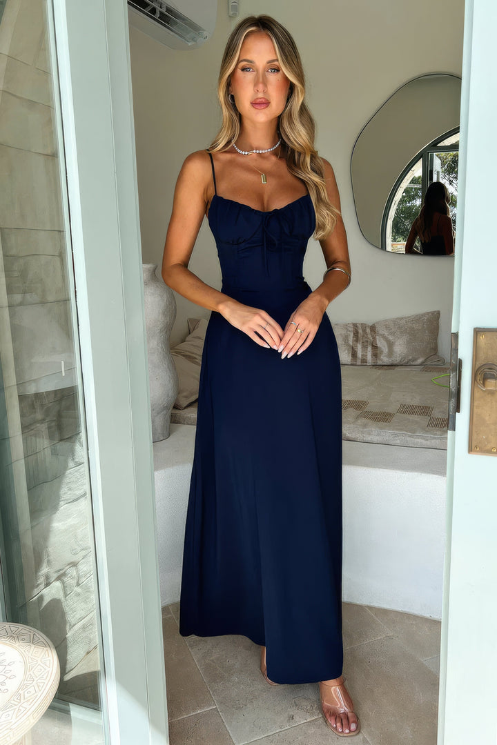 Feminine women's sleeveless A-line maxi dress, tie-front detail. Elegant for summer gatherings.