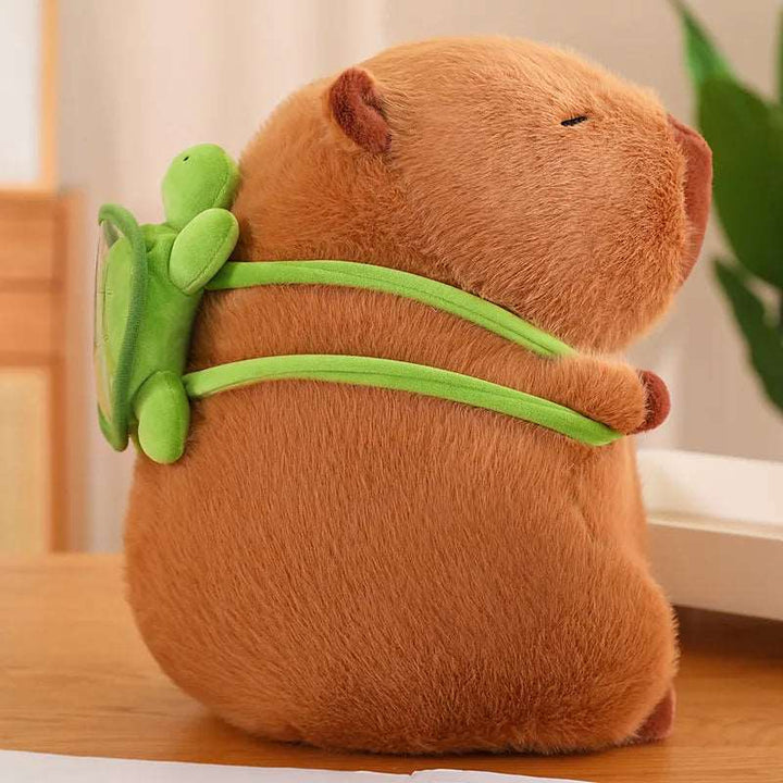 Capybara-Plüschtier mit grünem Schildkröten-Rucksack, braun, mit süßem Gesichtsausdruck, perfekt für Kinderzimmer.