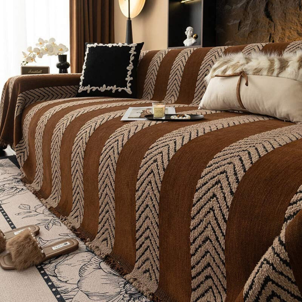 Unisex chenille herringbone throw draped over a sofa, pet-friendly and easy care