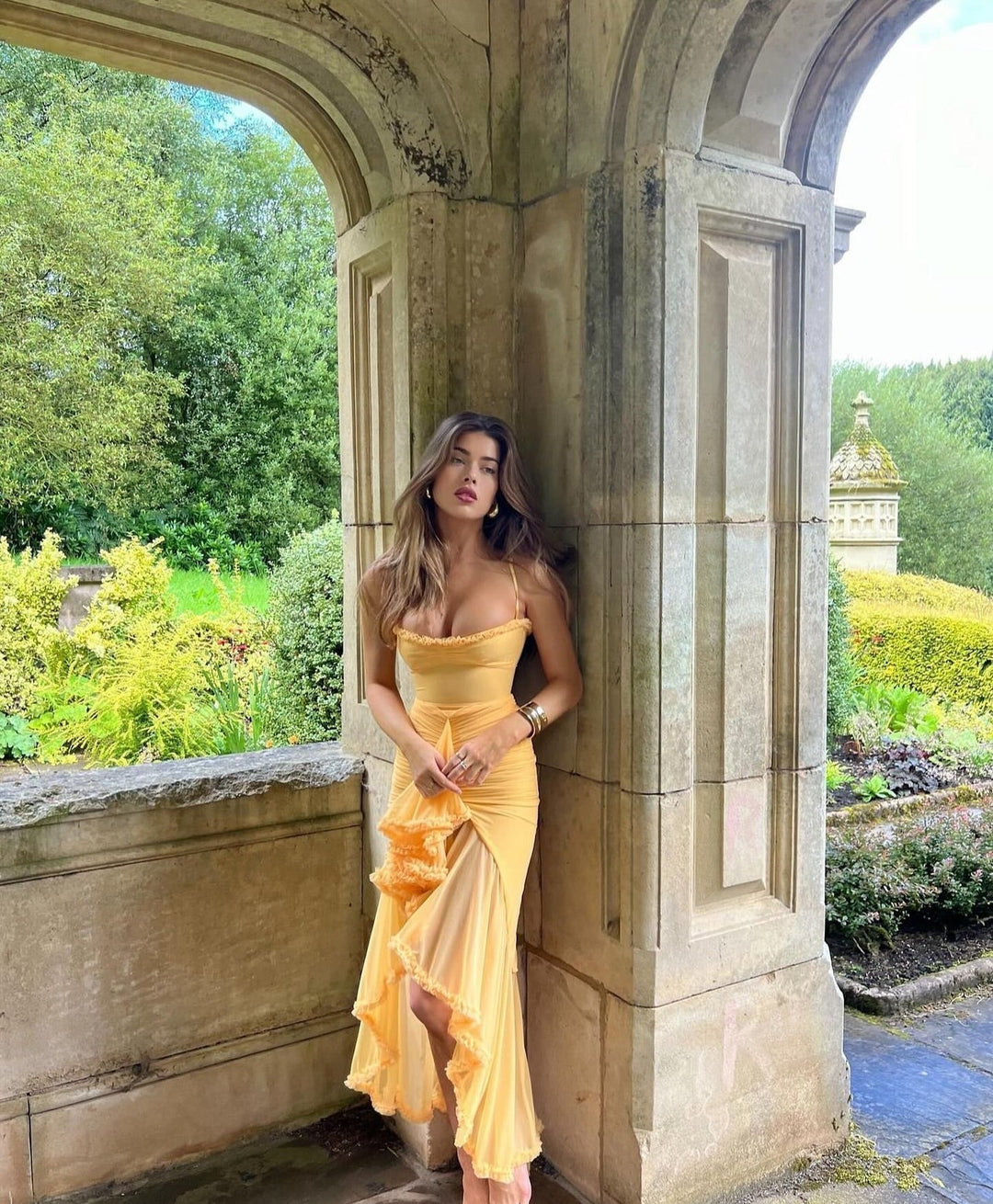 Maxi ruffle dress, a chic and elegant wedding guest outfit. Women's formal wear for summer parties.
