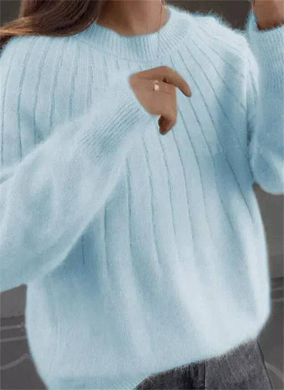 Woman modeling a cozy textured knit sweater, showcasing its chic style and comfortable fall/winter fashion.