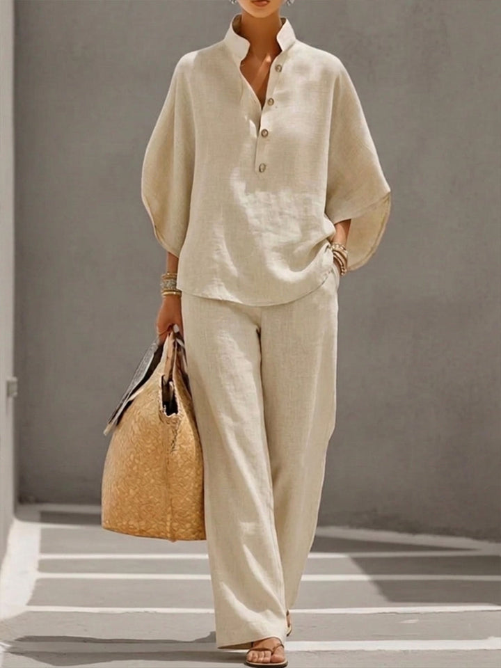 Chic women's two-piece set featuring a batwing blouse & wide leg trousers. Elegant casual matching outfit.