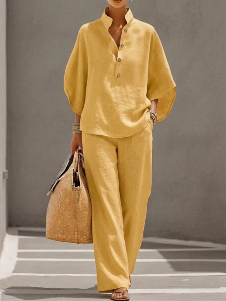 Versatile women's two-piece clothing set with a comfortable batwing blouse and wide leg trousers.