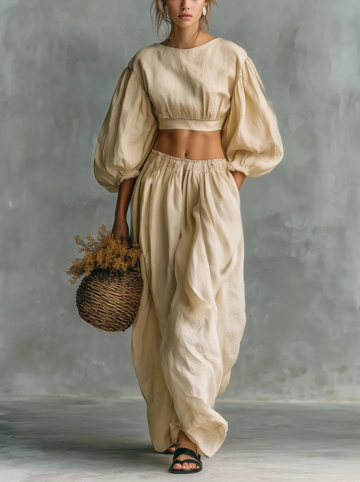Stylish women's two-piece set with chic balloon sleeves, a cropped top, and comfortable wide-leg trousers. Casual fit.