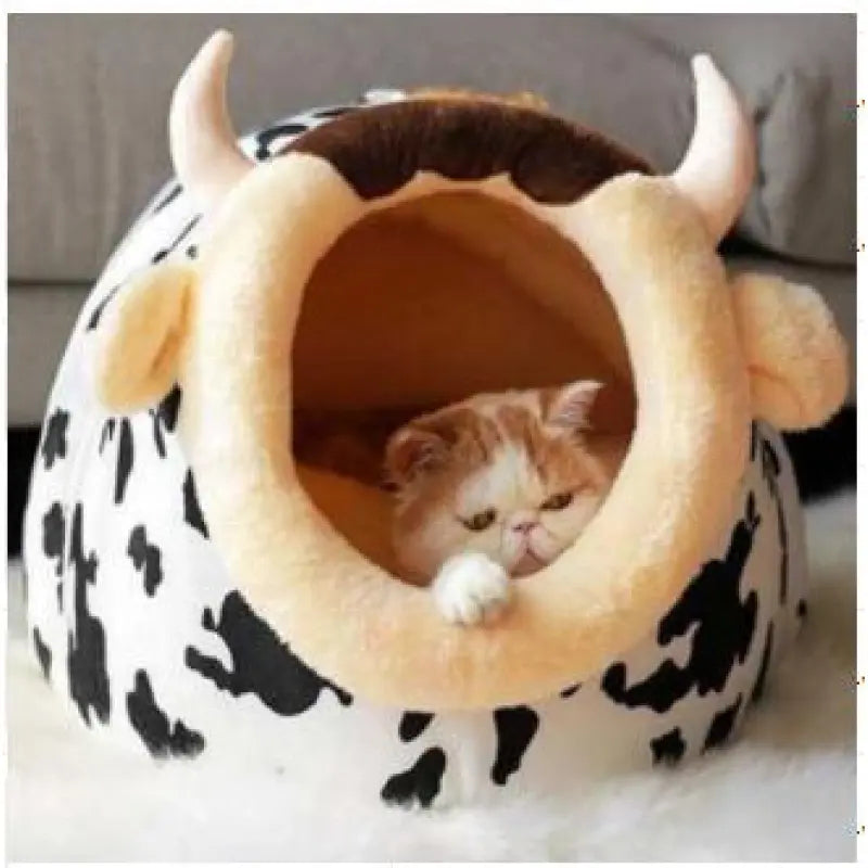 Cozy cat bed with playful black and white cow design, soft plush for feline comfort