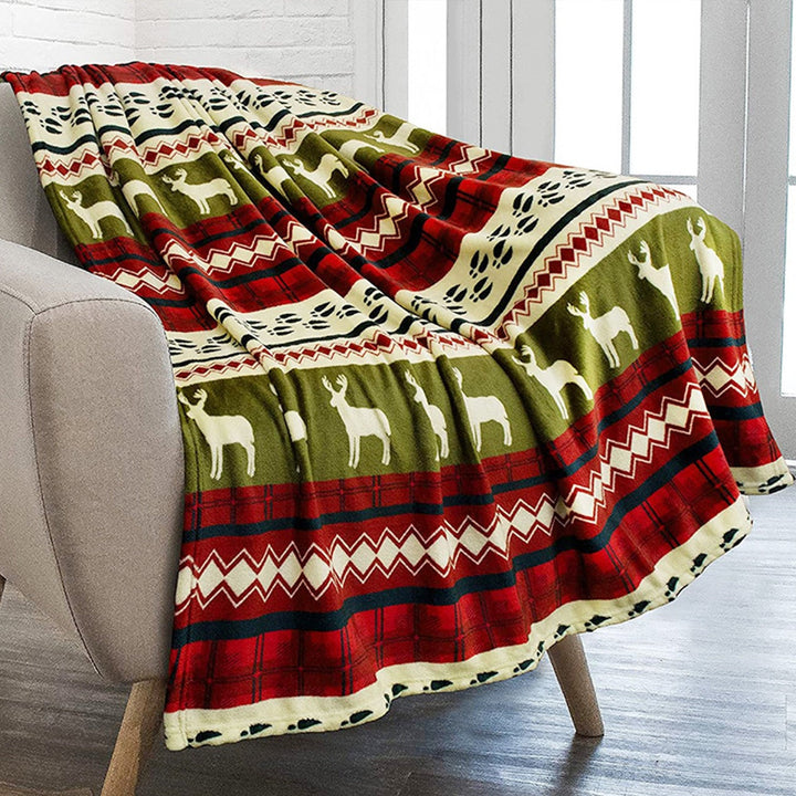 Soft home accent blanket featuring a winter reindeer and snowflake design, ideal for festive decor