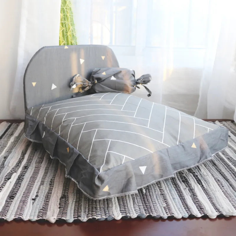Soft dog bed with an elevated backrest design, providing support and comfort for small pets