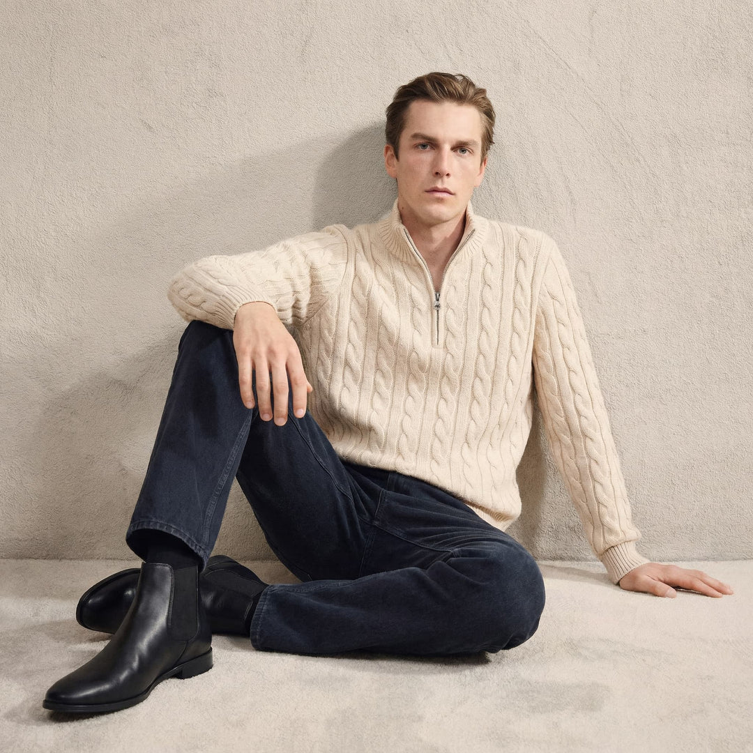 Pair of Men's Stratton blue leather Chelsea boots on a wooden floor. Elegant dress boots for modern men.