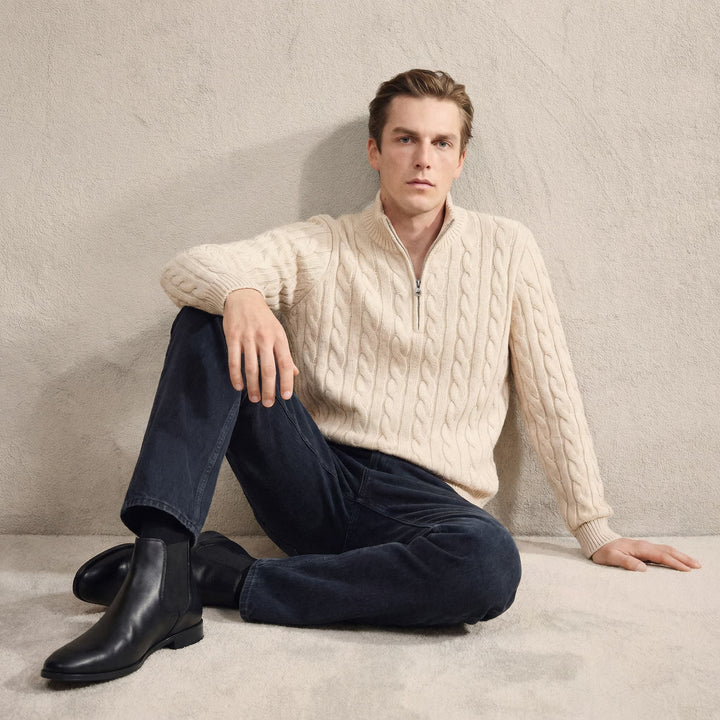 Pair of Men's Stratton blue leather Chelsea boots on a wooden floor. Elegant dress boots for modern men.