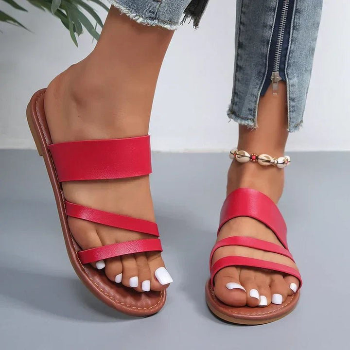 Lightweight women's casual sandals, cushioned flat base with chic cross-straps, perfect for summer.