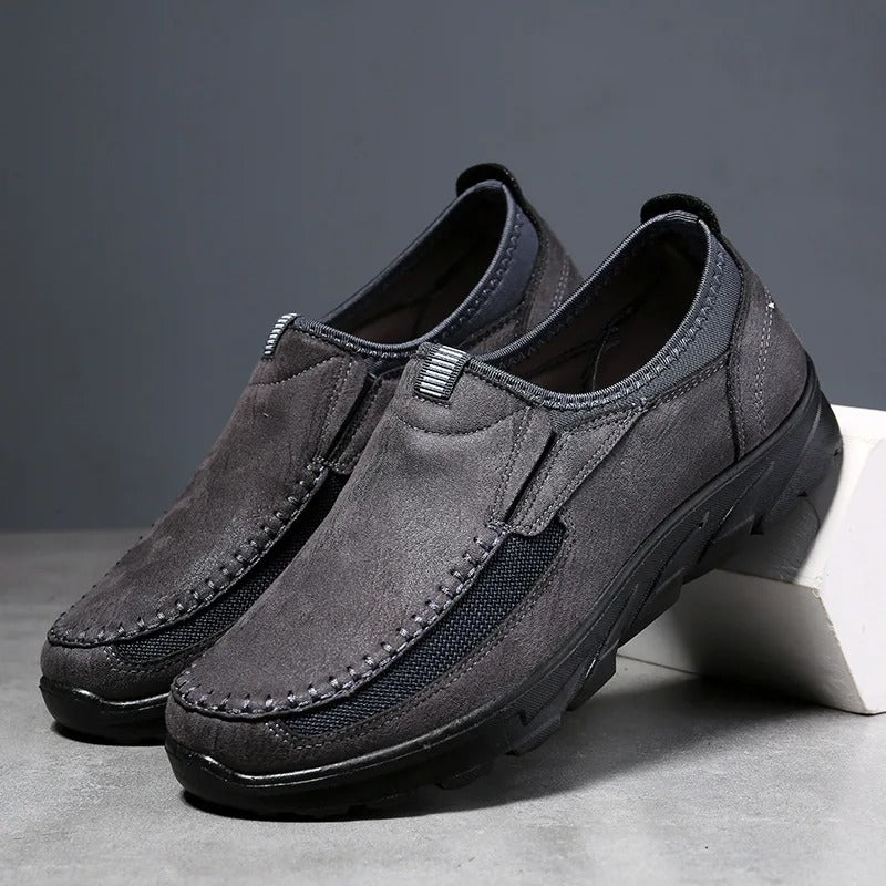 Black casual men's slip-on loafers. Cushioned for everyday comfort & features reliable traction.