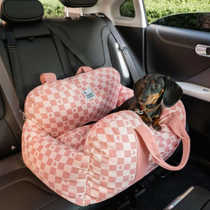Dog car seat booster, grey, with built-in harness attachment for security.