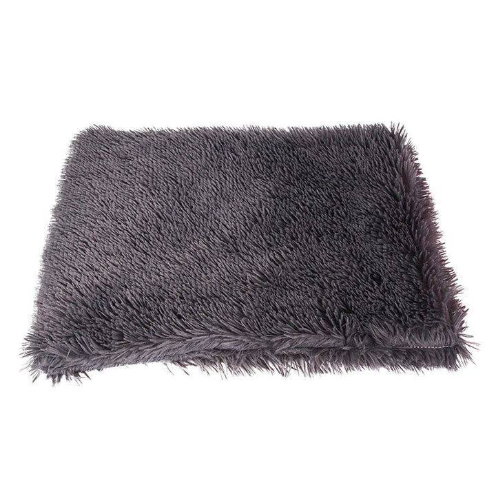 Puppy snoozing contently on a gray reversible calming pet blanket, anxiety relief for pets