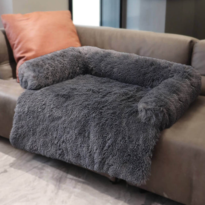 Detailed shot of the calming pet furniture protector's fuzzy faux fur texture and elevated backrest