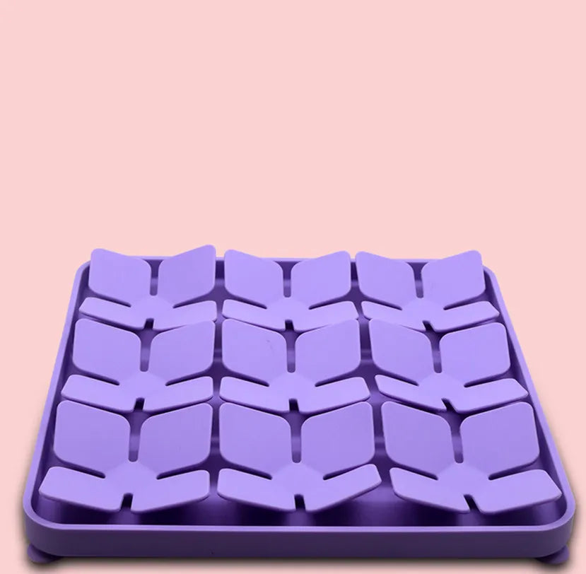 Overhead view of a dog snuffle mat, a slow feeder interactive toy with various fabric strands.