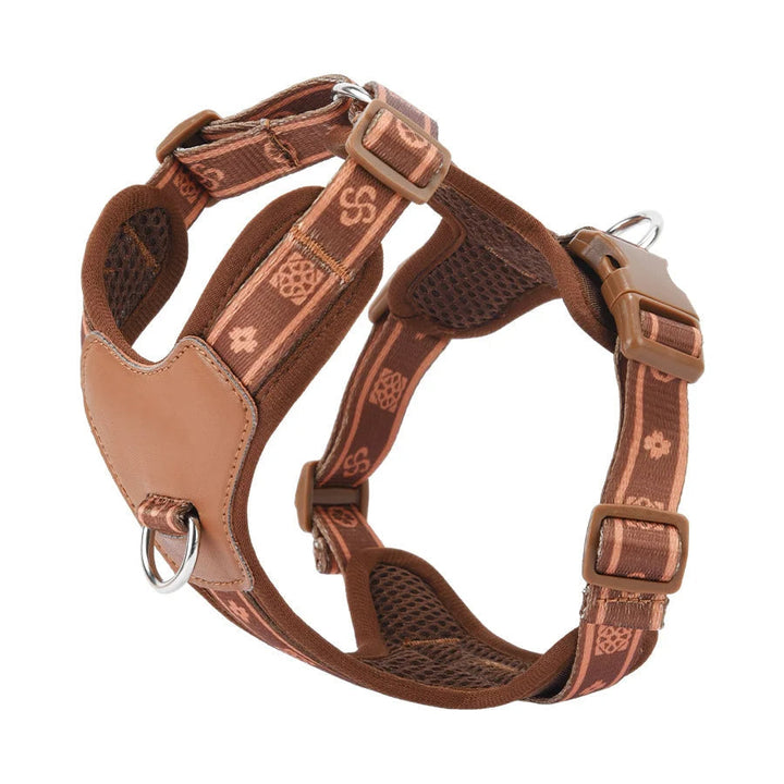 Dog wearing a black adjustable harness with reflective accents, showing breathable mesh for comfort.