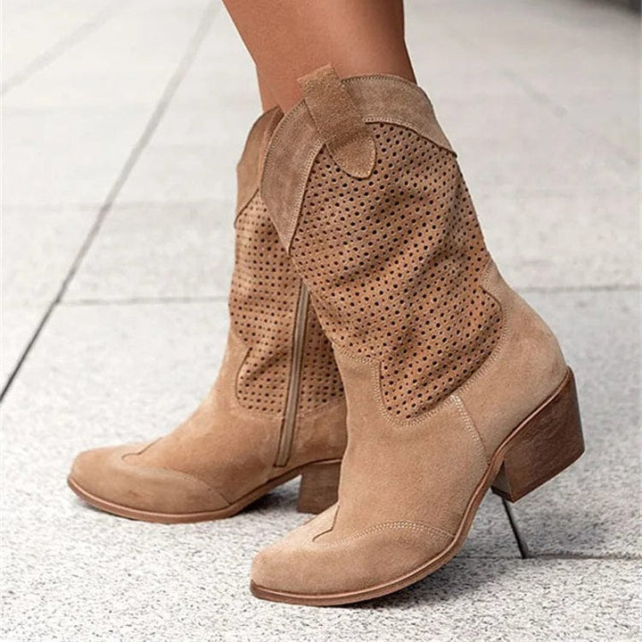 Women's side-zip western ankle boots with comfortable block heel & stylish perforated panels.