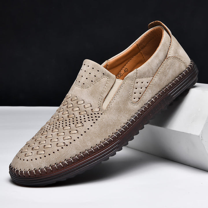 Perforated texture on men's comfort footwear, breathable design for cool, all-day casual wear.