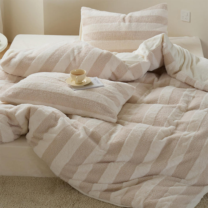 Velvet and sherpa striped sheet set, creating a warm and inviting bedroom ambiance