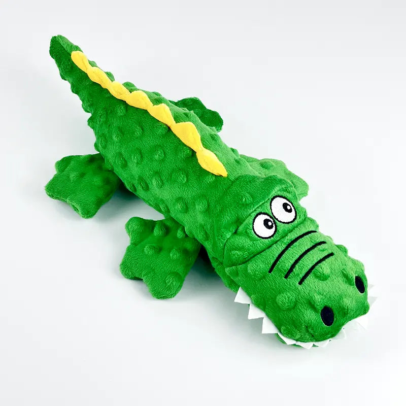 Green crocodile dog toy, a sturdy chew toy with an internal squeaker for pet engagement and dental care.