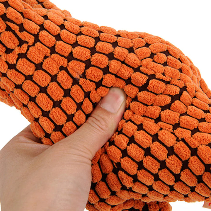 Close-up of a robust purple plush dog toy, showcasing its durable fabric