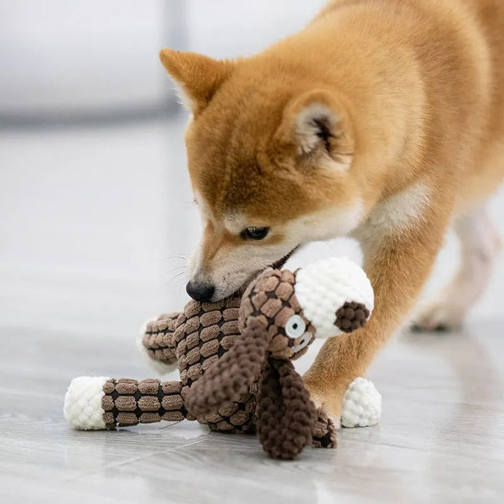 Close-up of the robust stitching on durable plush dog toy for aggressive chewers