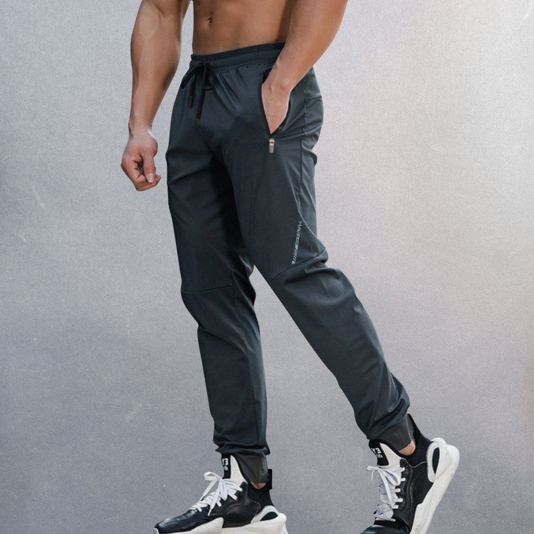 Elastische Herren Sporthose, atmungsaktiv mit Reißverschluss, ideal für Sport und Alltag, in modernem Design.
