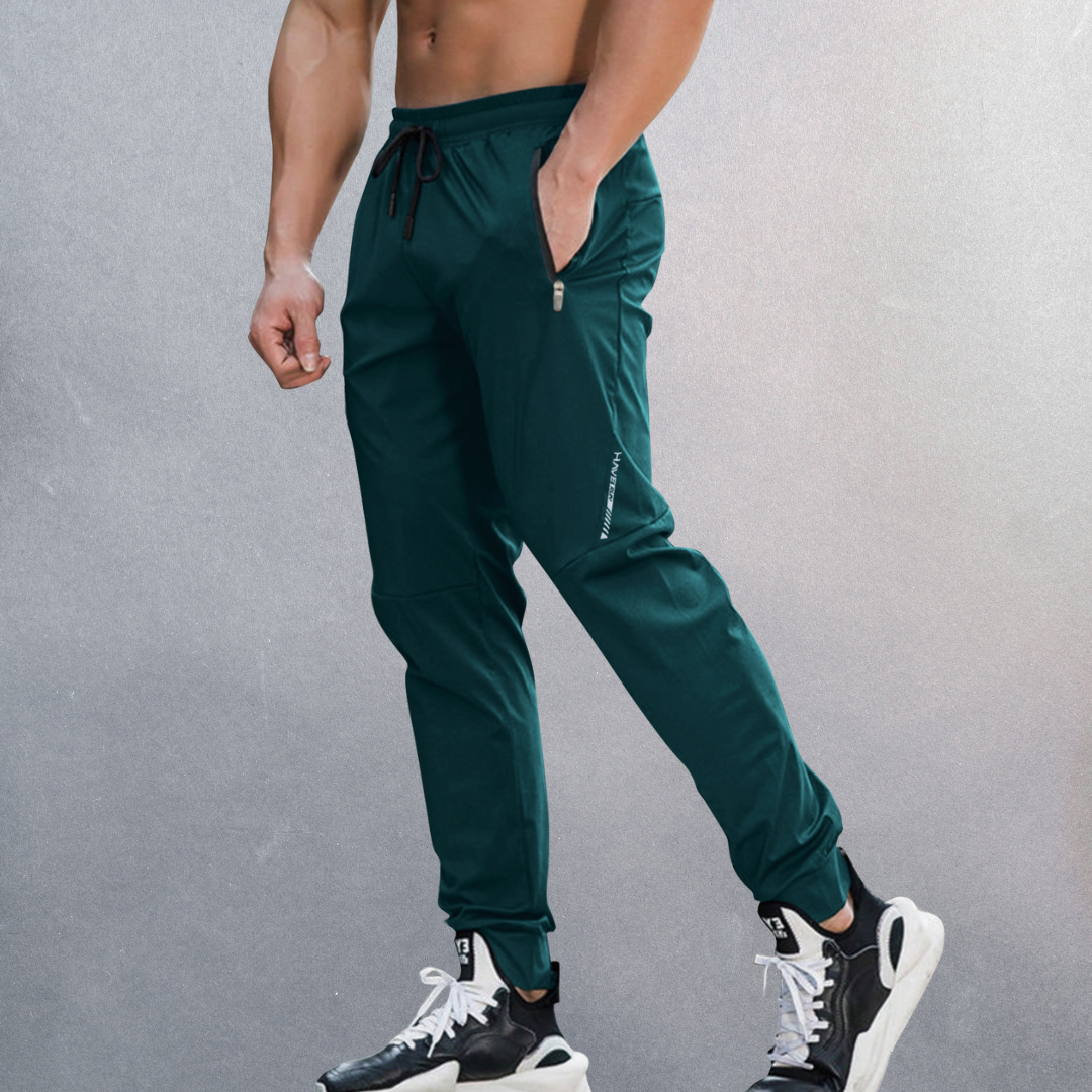 Elastische Herren Sporthose, atmungsaktiv mit Reißverschluss, ideal für Sport und Alltag, in modernem Design.