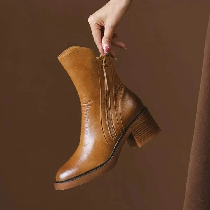 Stylish brown women's high-heel ankle boots, a comfortable & elegant choice for sophisticated footwear.