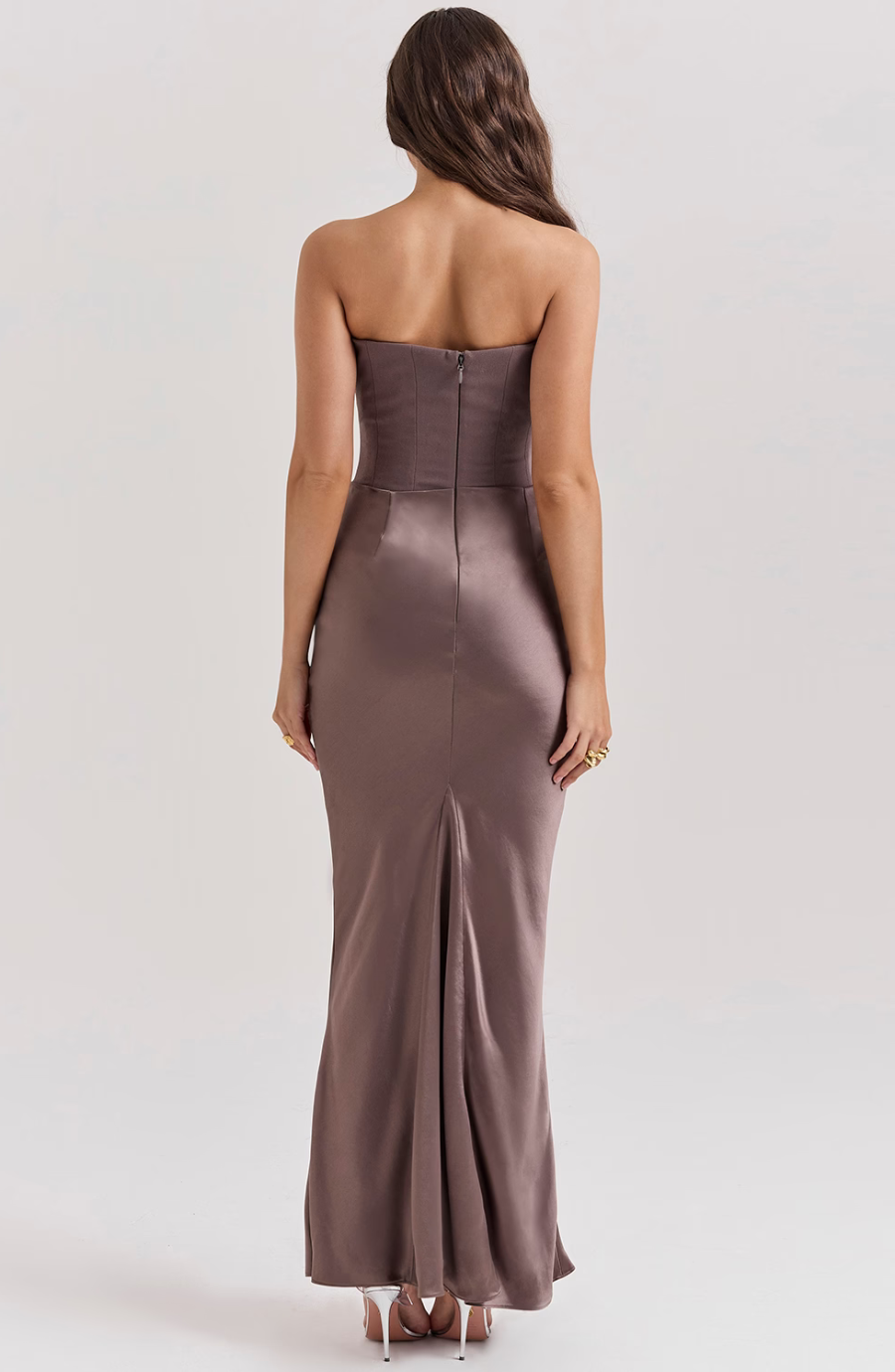 Elegant black strapless wedding guest dress, a long formal gown with corset structure.